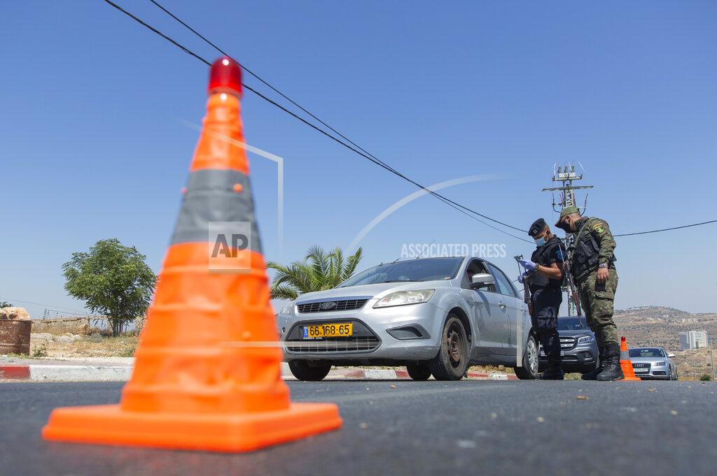 Nasser Nasser A Palestinian security unit mans a checkpoint at an entrance of in the West Bank city of Ramallah, Thursday, July 2, 2020. The Palestinian Authority has announced a five-day total lockdown in the West Bank starting Friday, in response to a major increase in coronavirus cases and deaths in recent days. (AP Photo/Nasser Nasser)