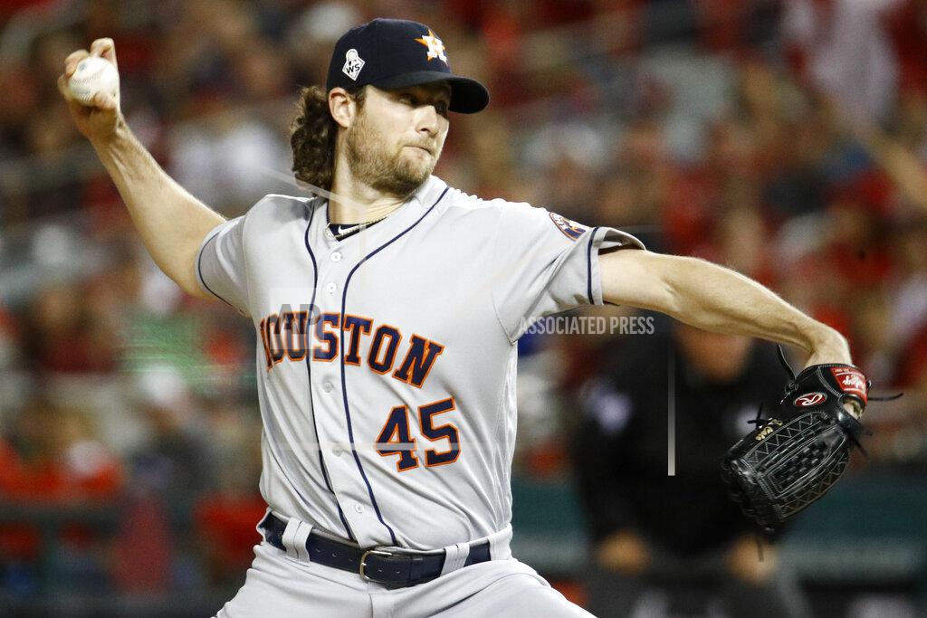 FILE - In this Oct. 27, 2019, file photo, Houston Astros starting pitcher Gerrit Cole throws against the Washington Nationals during the first inning of Game 5 of the baseball World Series in Washington. Gerrit Cole, the top pitcher on the free-agent market, was to meet with New York Yankees officials in California on Tuesday, Dec. 3, 2019. General manager Brian Cashman, manager Aaron Boone and new Yankees pitching coach Matt Blake made the trip to speak with the 29-year-old right-hander, a person familiar with the planning said. The person spoke to The Associated Press on condition of anonymity because the meeting was not announced.(AP Photo/Patrick Semansky, File)