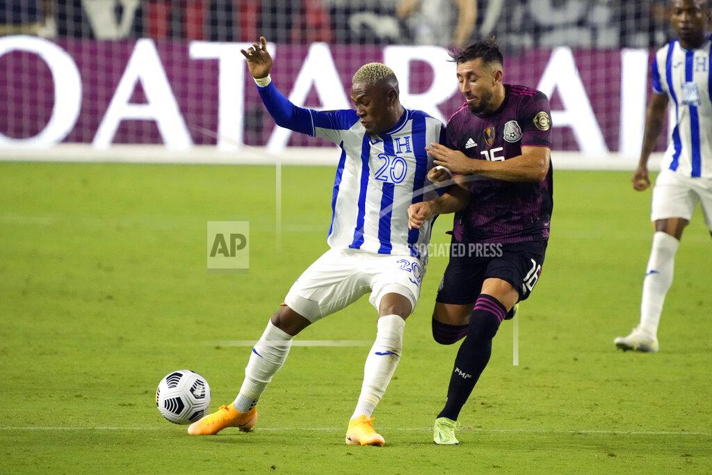 Rick Scuteri Honduras midfielder Deybi Flores (20) shields Mexico midfielder Hector Herrera from the ball during the second half of a CONCACAF Gold Cup soccer match Saturday, July 24, 2021, in Glendale, Ariz. (AP Photo/Rick Scuteri)
