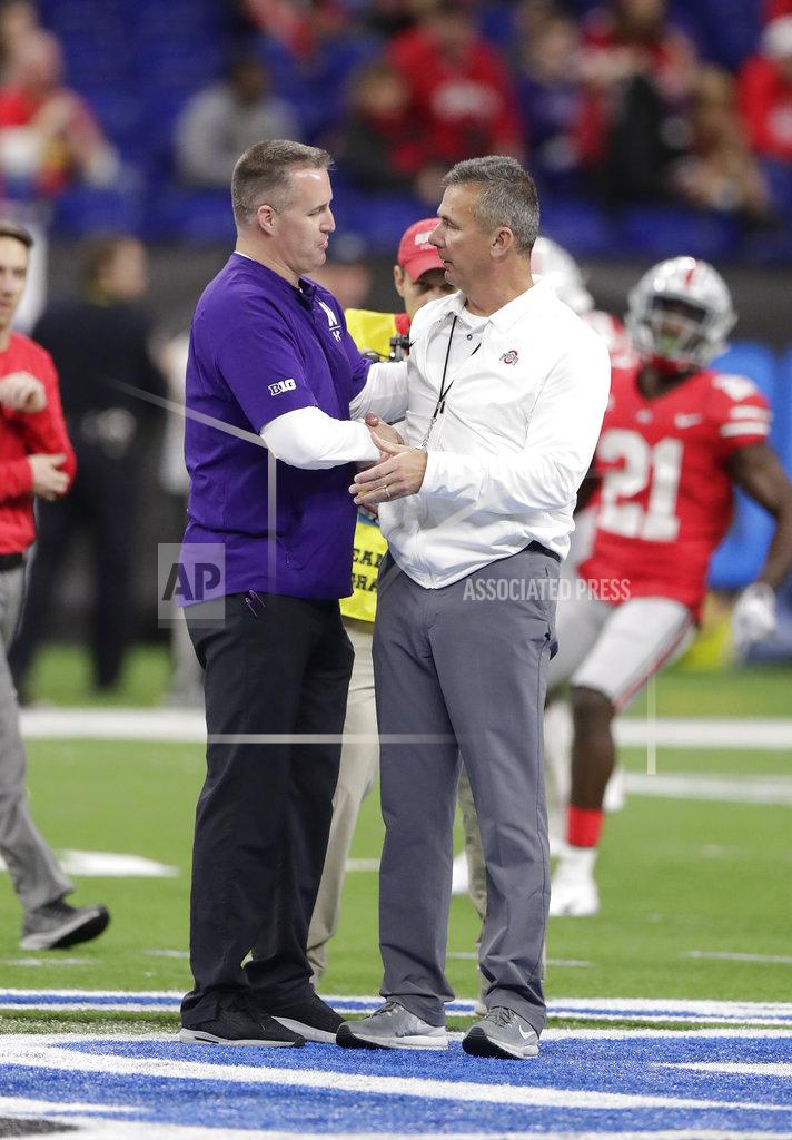 Michael Conroy Northwestern coach Pat Fitzgerald, left, shakes hands with Ohio State coach Urban Meyer before the Big Ten championship NCAA college football game Saturday, Dec. 1, 2018, in Indianapolis. (AP Photo/Michael Conroy)