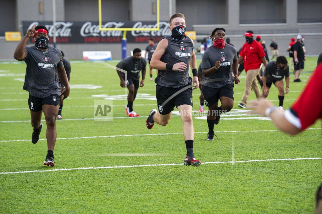 Austin Peay players warm up for the team's NCAA college football game against Central Arkansas on Saturday, Aug. 29, 2020, in Montgomery, Ala. (Jake Crandall/The Montgomery Advertiser via AP)