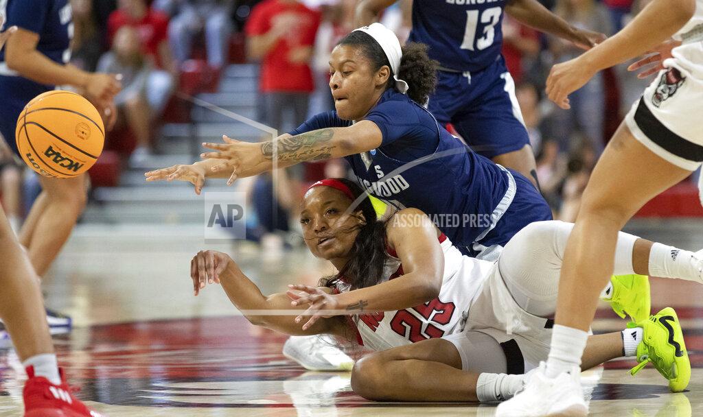 Ben Mckeown North Carolina State's Kayla Jones (25) passes off after battling with Longwood's Tra'Dayja Smith (14) for a loose ball during the first half of a college basketball game in the first round of the NCAA tournament in Raleigh, N.C., Saturday, March 19, 2022. (AP Photo/Ben McKeown)