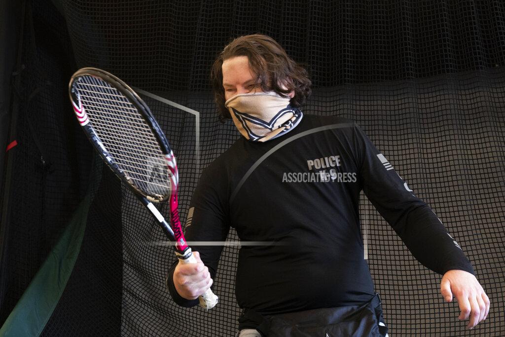 Mark Lennihan Joe DiMeo holds a tennis racket as he works in a physical therapy session, Jan. 25, 2021 in New York, six months after an extremely rare double hand and face transplant. Since leaving the hospital in November, DiMeo has been in intensive rehabilitation, devoting hours daily to physical, occupational and speech therapy. (AP Photo/Mark Lennihan)