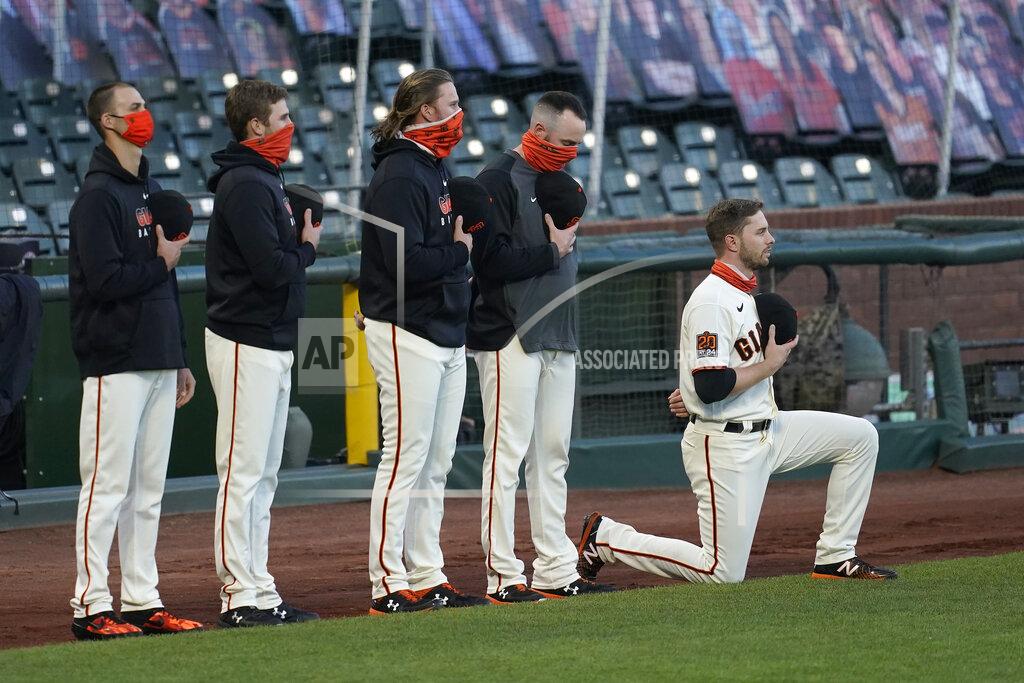 Jeff Chiu San Francisco Giants' Austin Slater, right, kneels during the national anthem before a baseball game between the Giants and the Colorado Rockies in San Francisco, Tuesday, Sept. 22, 2020. (AP Photo/Jeff Chiu)