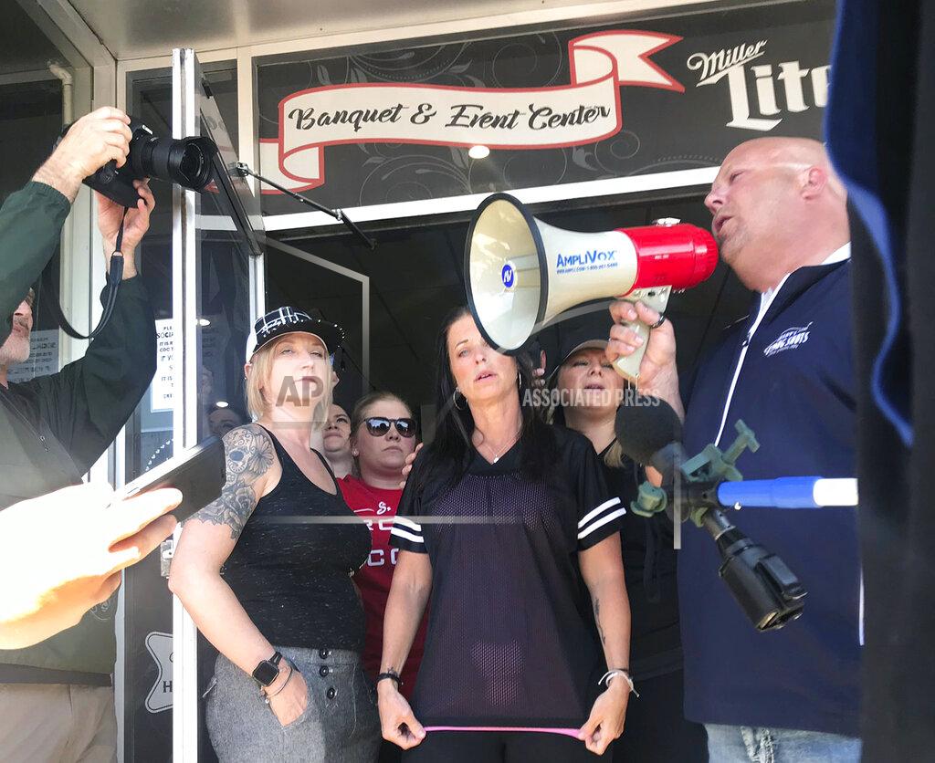 Kirsti Marohn Kris Schiffler, right, the owner of Shady's Hometown Tavern in Albany, Minn. tells supporters outside his business that he's not opening his bar and grill Monday, May 18, 2020, on the advice of his attorney, after getting a call from Minnesota Attorney General Keith Ellison. (Kirsti Marohn/Minnesota Public Radio via AP)