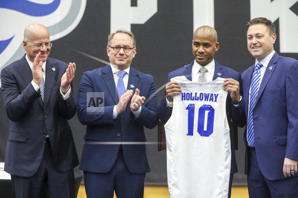 Andrew Mills Kevin Marino, chair of the Seton Hall University Board of Regents, from left, Seton Hall President Joseph E. Nyre, new men's basketball coach Shaheen Holloway and SHU Athletic Director Bryan Felt, attend the introductory news conference for Holloway at Walsh Gym on Thursday, March 31, 2022, in South Orange, N.J. (Andrew Mills/NJ Advance Media via AP)