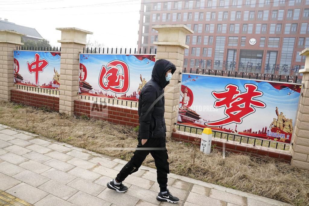 Ng Han Guan A man passes by the words "China Dream" outside the entrance to the Wuhan Institute of Virology during a visit by a World Health Organization team in Wuhan in China's Hubei province on Wednesday, Feb. 3, 2021. The WHO team is investigating the origins of the coronavirus pandemic has visited two disease control centers in the province. (AP Photo/Ng Han Guan)