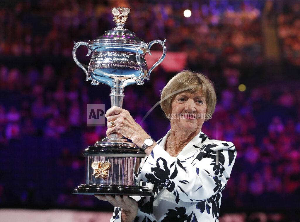 Lee Jin-Man FILE - In this Jan. 27, 2020, file photo, former Australian Open champion Margaret Court holds up the women's Australian Open trophy, the Daphne Ackhurst Memorial Cup, as her 50th anniversary of her Grand Slam is celebrated at the Australian Open tennis championship in Melbourne, Australia. Australia media are reporting that controversial former tennis champion Margaret Court will receive the country’s top award in the Australia Day honors list, and the apparent decision is already being criticized. The 78-year-old’s appointment as Companion of the Order of Australia was reported to be revealed late on Monday, Jan. 26, 2021, but it was leaked on social media. (AP Photo/Lee Jin-man, File)