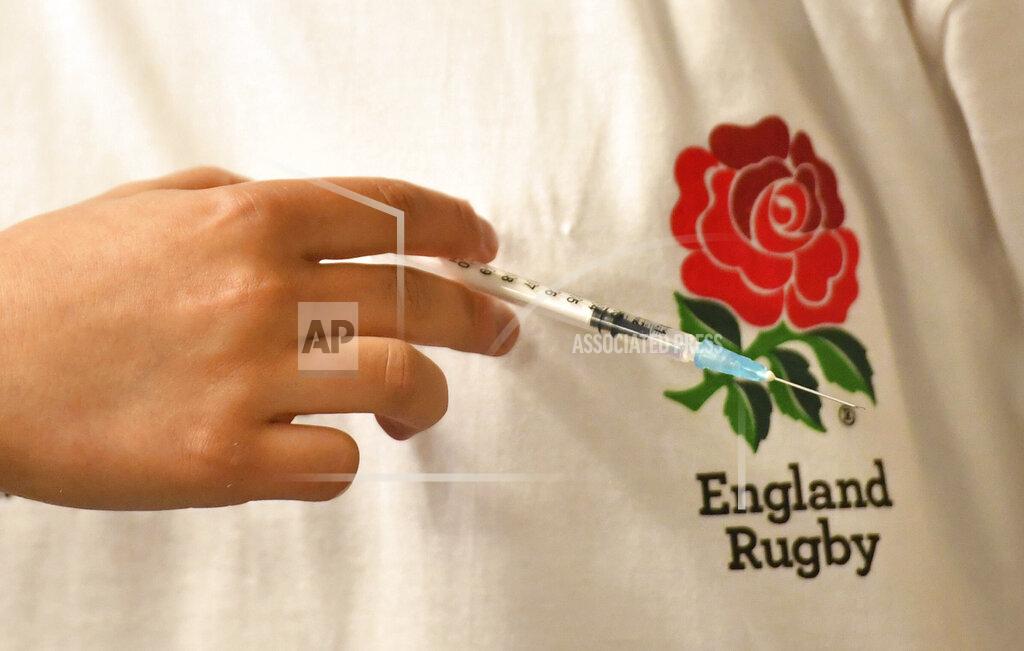 A person prepares a coronavirus vaccine shot at a surge vaccine operation set up at Twickenham rugby stadium, south-west London, Monday May 31, 2021. Up to 15,000 doses of vaccine are ready to be administered at the walk-in centre which has been set up for residents of north-west London in response to an increase in the number of coronavirus cases in the area. (Dominic Lipinski/PA via AP)
