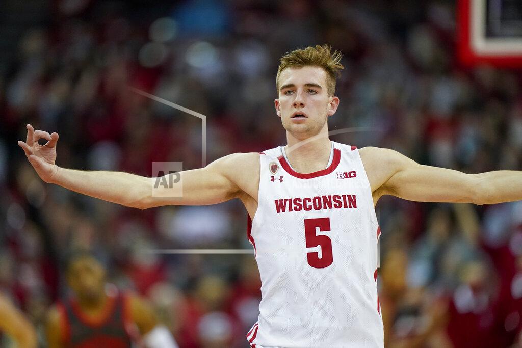Andy Manis Wisconsin's Tyler Wahl (5) signals after hitting a 3-point basket against Ohio State during the first half of an NCAA college basketball game Thursday, Jan. 13, 2022, in Madison, Wis. (AP Photo/Andy Manis)