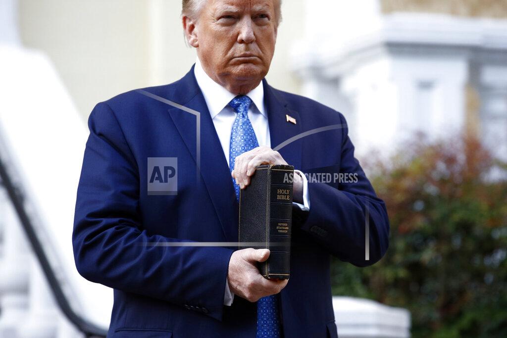 FILE - In this June 1, 2020, file photo, President Donald Trump holds a Bible as he visits outside St. John's Church across Lafayette Park from the White House in Washington. Part of the church was set on fire during protests on Sunday night. (AP Photo/Patrick Semansky, File)