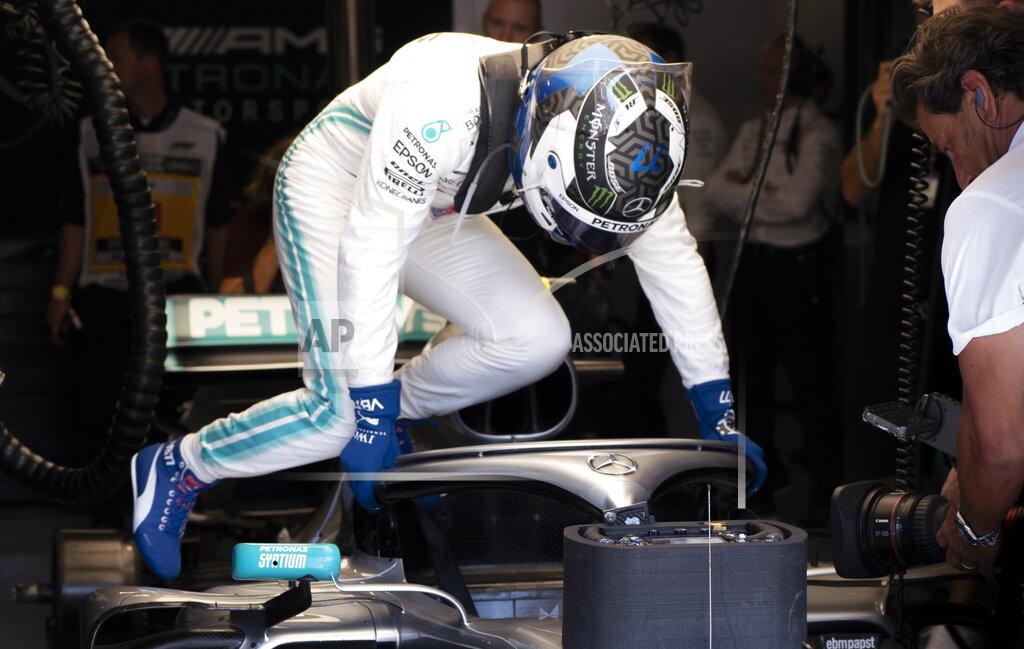 Paul Chiasson Mercedes Motorsport driver Valtteri Bottas of Finland slips into his car during the second practice session at the Formula One Canadian Grand Prix auto race, Friday, June 7, 2019, in Montreal. (Paul Chiasson/The Canadian Press via AP)