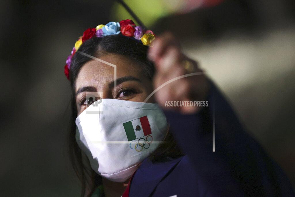 Hannah Mckay A member from Team Mexico arrives during the opening ceremony in the Olympic Stadium at the 2020 Summer Olympics, Friday, July 23, 2021, in Tokyo, Japan. (Hannah McKay/Pool Photo via AP)