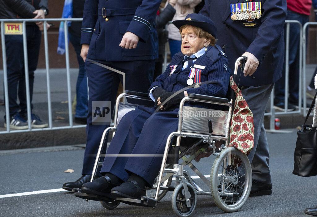 Mark Baker Iris Terry, 103-year-old war widow, participates in the Anzac Day parade in Sydney, Australia, Sunday, April 25, 2021. Australians and New Zealanders paid tribute to their war dead Sunday as both nations prepared to withdraw from their longest war in Afghanistan. (AP Photo/Mark Baker)