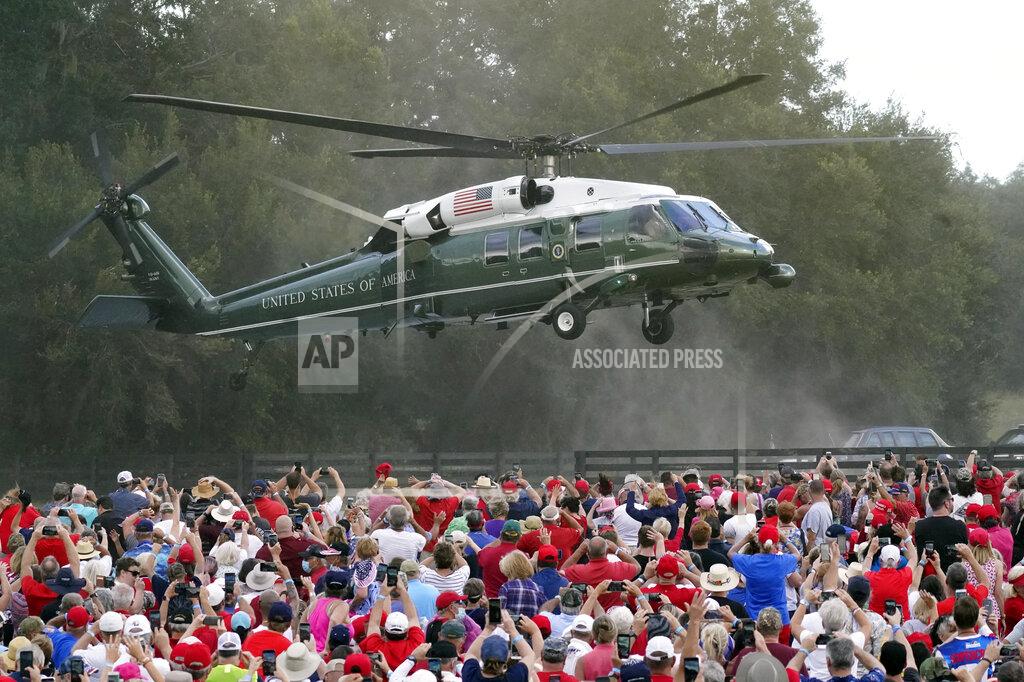 John Raoux President Donald Trump arrives in the Marine One helicopter at a campaign rally as supporters cheer Friday, Oct. 23, 2020, in The Villages, Fla. (AP Photo/John Raoux)