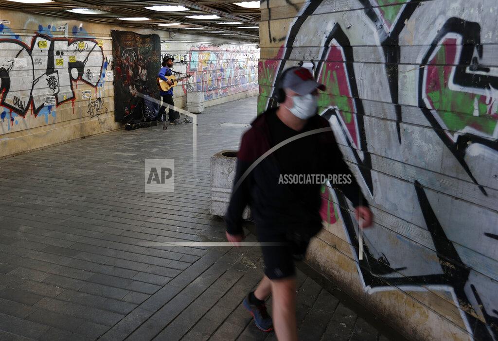 Darko Vojinovic A man wearing face mask to protect against coroavirus, walks through an underground passage in Belgrade, Serbia, Tuesday, May 5, 2020. Residents of the Serbian capital have flocked to outdoor cafes and restaurants as they enjoyed further easing of restrictions implemented nearly two months ago to combat the spread of coronavirus. Serbia's President Aleksandar Vucic has said the formal lifting of a state of emergency imposed in mid-March will take place later this week. (AP Photo/Darko Vojinovic)