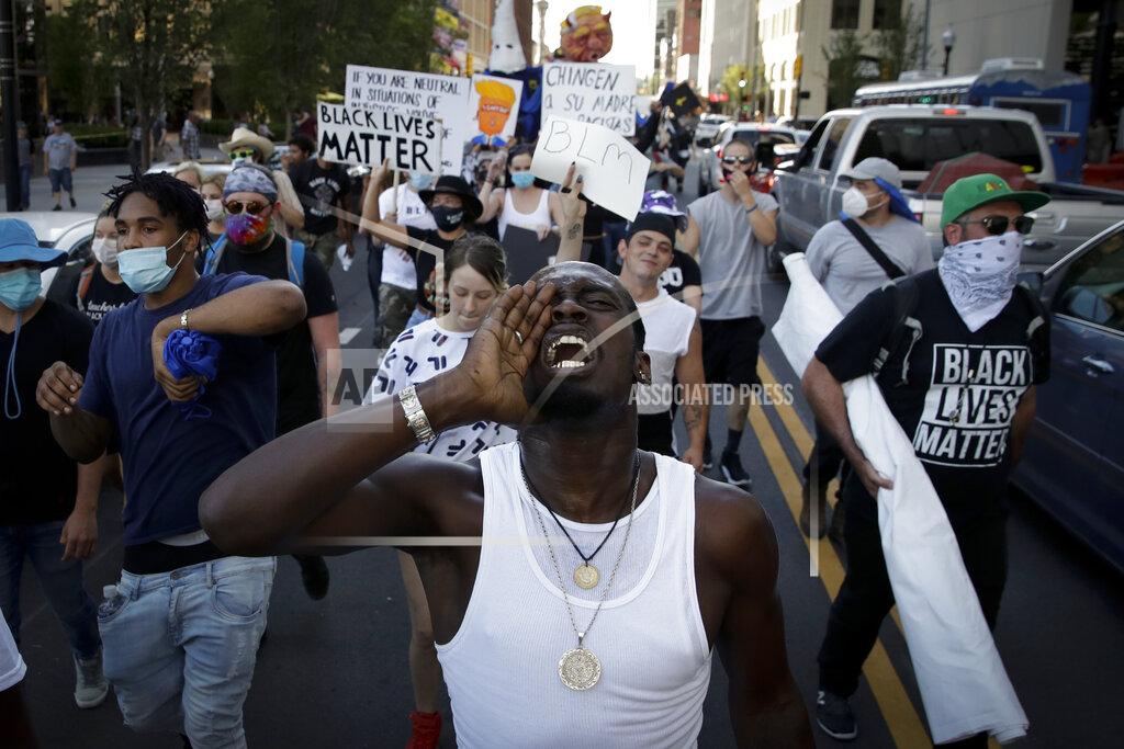Charlie Riedel FILE - In this June 20, 2020, file photo, demonstrators march outside the BOK Center where President Trump will hold a campaign rally in Tulsa, Okla. (AP Photo/Charlie Riedel, File)