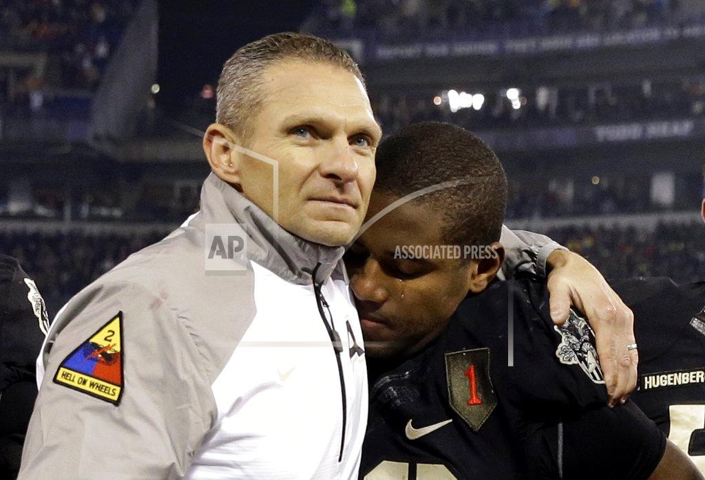 Patrick Semansky FILE - In this Dec. 13, 2014, file photo, Army head coach Jeff Monken, left, embraces running back Larry Dixon after losing 17-10 to Navy, in Baltimore. With Army ranked No. 22, the Cadets (9-2) try to beat Navy (3-9) for the third straight time Saturday in the storied series.(AP Photo/Patrick Semansky, File)