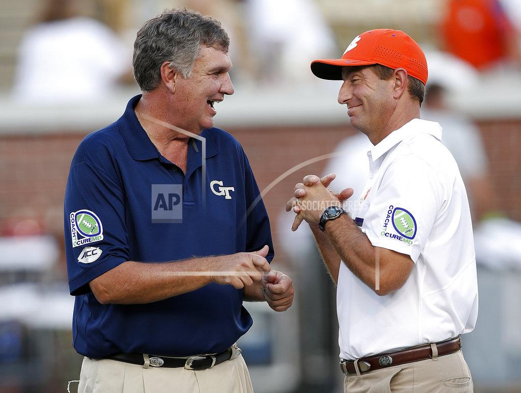 John Bazemore FILE - In this Sept. 22, 2016, file photo, Georgia Tech head coach Paul Johnson, left, and Clemson head coach Dabo Swinney laugh as they speak on the field before an NCAA college football game in Atlanta. The schools meet on Saturday. (AP Photo/John Bazemore, File)