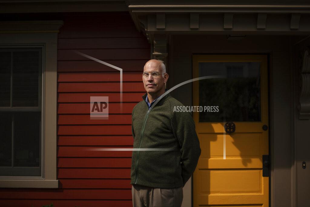 David Goldman Seth Handy, 53, a direct descendant of a Pilgrim who came over on the Mayflower, stands for a portrait outside his home in Providence, R.I., Tuesday, Sept. 22, 2020. For Handy, it's a difficult issue to reconcile. "The pilgrims came out of religious persecution in England. And I'm very proud of the fact that they set off to create their own independent culture," said Handy. "But they came to a place where there was existing culture. And, you know, the history is not friendly and that is troublesome," he said. Handy added that it's more important now than ever now to "recognize everyone's role in our history and the great diversity of this country." (AP Photo/David Goldman)