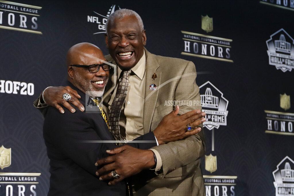 Mark Humphrey FILE - Hall of Fame Class of 2020 Donnie Shell, left, hugs Harold Carmichael at the NFL Honors football award show in Miami, in this Saturday, Feb. 1, 2020, file photo. Built more like an NBA player at 6-foot-8, Harold Carmichael turned to football because he couldn’t perform basketball’s most basic skill. Carmichael couldn't dribble. It worked out for the best. Carmichael used his size to outjump and overpower defenders, catching more passes for more yards and touchdowns than any player in the history of the Philadelphia Eagles. The gentle giant then waited patiently for three decades before he was elected to the Pro Football Hall of Fame as part of last year’s special centennial class. (AP Photo/Mark Humphrey, File)