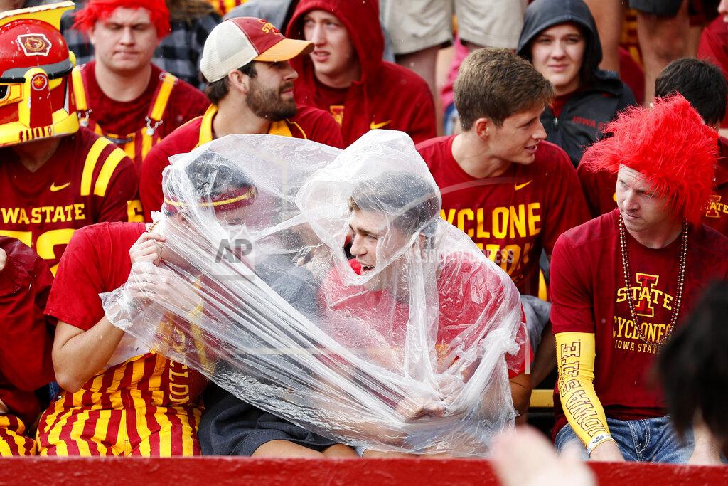 Charlie Neibergall Iowa State fans take cover during a lightning delay in the first half of an NCAA college football game against Iowa, Saturday, Sept. 14, 2019, in Ames, Iowa. (AP Photo/Charlie Neibergall)