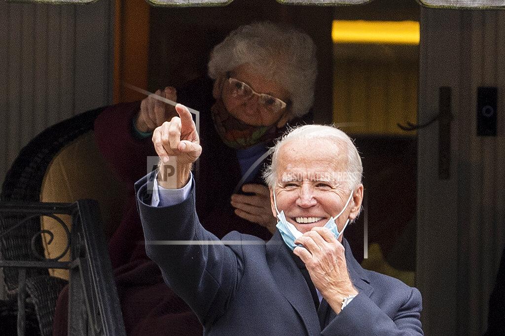 Jose F. Moreno Democratic presidential candidate, former Vice President Joe Biden, gestures and smiles from the front steps of his childhood home, during a visit on Election Day, Tuesday, Nov. 3, 2020, in Scranton, Pa. (Jose F. Moreno/The Philadelphia Inquirer via AP)