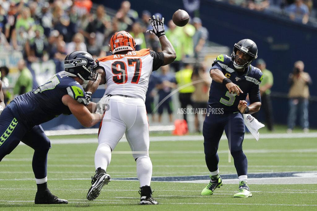 John Froschauer Seattle Seahawks quarterback Russell Wilson, right, passes under pressure from Cincinnati Bengals defensive tackle Geno Atkins (97) during the first half of an NFL football game, Sunday, Sept. 8, 2019, in Seattle. (AP Photo/John Froschauer)