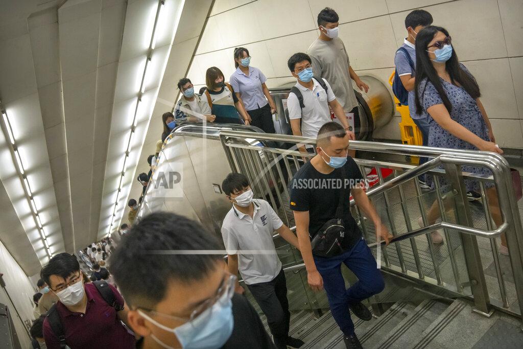 Mark Schiefelbein People wearing face masks to protect against COVID-19 walk up stairs in a subway station during the morning rush hour in Beijing, Wednesday, Aug. 4, 2021. The coronavirus’s delta variant is challenging China’s costly strategy of isolating cities, prompting warnings that Chinese leaders who were confident they could keep the virus out of the country need a less disruptive approach. (AP Photo/Mark Schiefelbein)
