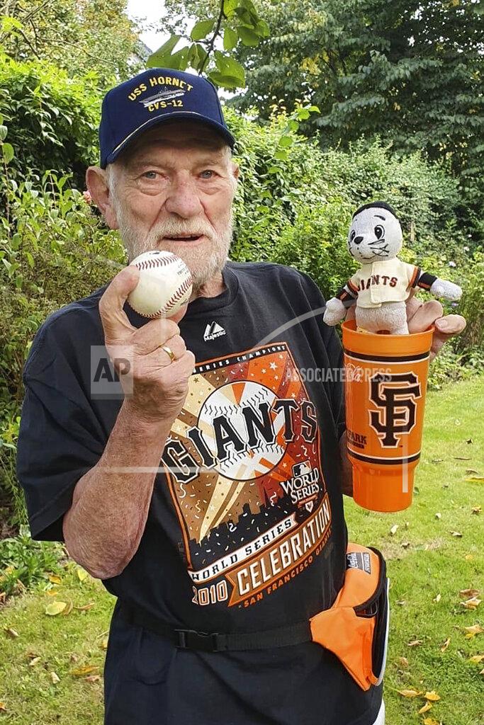 Christiane Pohl-Rolfes This Wednesday, Sept. 23, 2020, photo provided by Christiane Pohl-Rolfes shows her father, San Francisco Giants fan Manner Pohl, holding a baseball in Flensburg, Germany. (Christiane Pohl-Rolfes via AP)