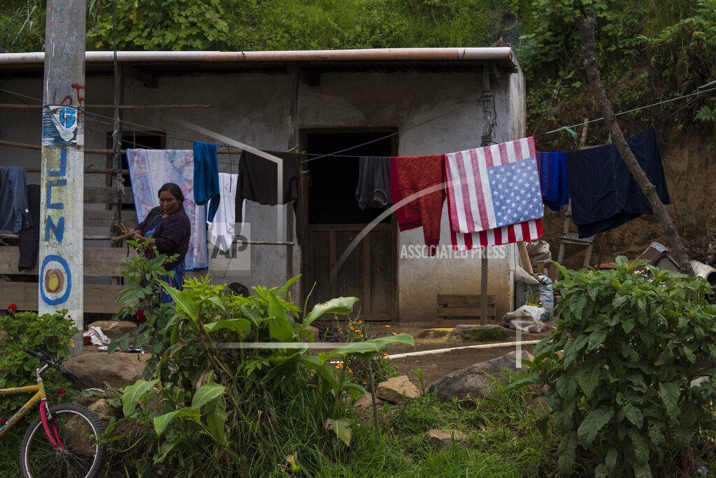 Moises Castillo A Mam Indigenous woman carries firewood at her home in San Martin Sacatepequez, Guatemala, Tuesday, June 8, 2021. The Mam Indigenous community is an agricultural place transformed with the remittances that migrants send to their families. (AP Photo/Moises Castillo)