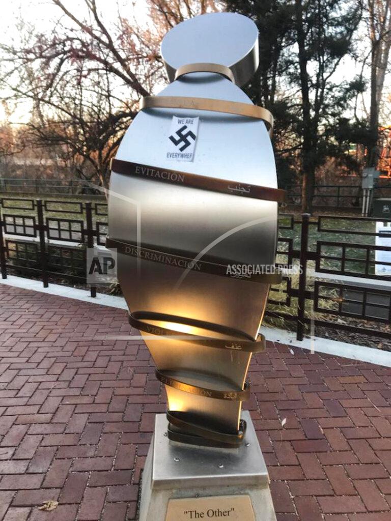 Uncredited In this photo provided by the Wassmuth Center for Human Rights, a swastika sticker is seen on a sculpture at the Idaho Anne Frank Human Rights Memorial in Boise, Idaho, on Tuesday, Dec. 8, 2020. Boise police are investigating after the memorial was defaced by swastika stickers earlier this week. The stickers, which included the words, "we are everywhere" as well as the Nazi insignia, were discovered Tuesday morning by a visitor to the memorial in downtown Boise. (Wassmuth Center for Human Rights via AP)