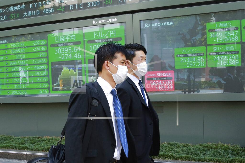 Koji Sasahara People walk by an electronic stock board of a securities firm in Tokyo, Wednesday, Sept. 15, 2021. Asian stock markets followed Wall Street down on Wednesday after U.S. inflation was lower than expected amid unease about the impact of the spread of the coronavirus's delta variant. (AP Photo/Koji Sasahara)
