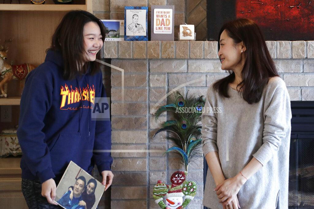 Elaine Thompson Jodie Chen, right, and her daughter, Mandy Luo, pose for a portrait in their home in Issaquah, Wash., on Monday, April 13, 2020. After being away from her daughter for three years, Chen arrived days earlier from China and is self-quarantining at home out of an abundance of caution for the COVID-19 coronavirus. The family is waiting for husband and father Daniel Hsu to be allowed to leave China and return home. (AP Photo/Elaine Thompson)