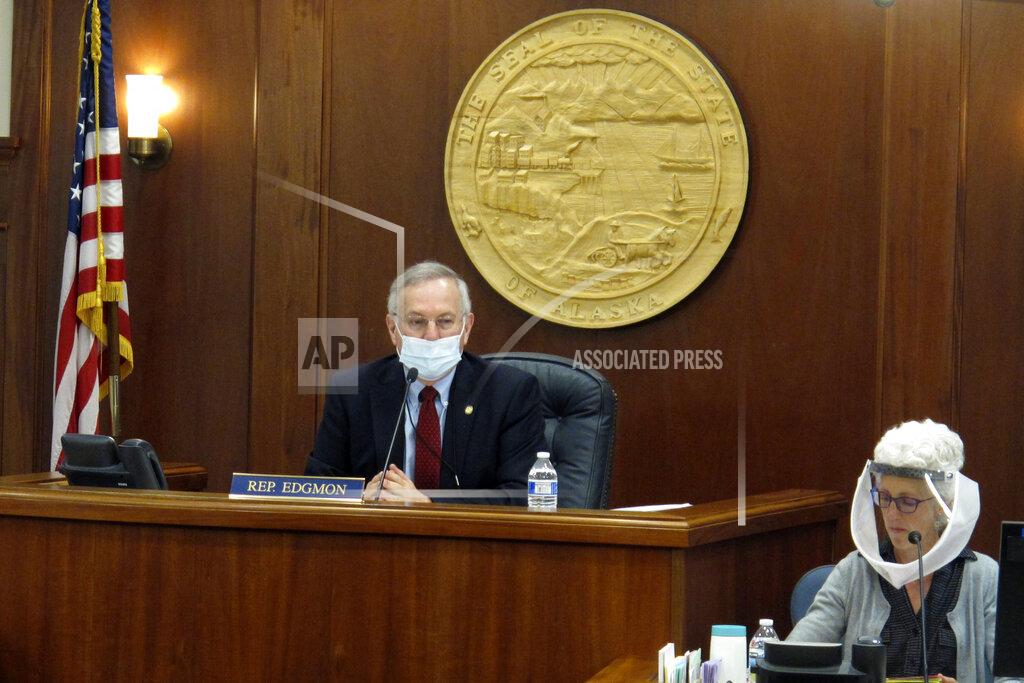 FILE - In this May 19, 2020, file photo, Alaska House Speaker Bryce Edgmon, left, presides over the House floor in Juneau, Alaska. Alaska lawmakers who each year relocate to a capital city accessible only by plane or boat are facing challenges in getting settled ahead of what is expected to be a difficult legislative session overshadowed by COVID-19. Speaker Edgmon, an independent from Dillingham, about 860 miles from Juneau, said pandemic concerns come at a time when lawmakers will need to make tough budget decisions. (AP Photo/Becky Bohrer, File)