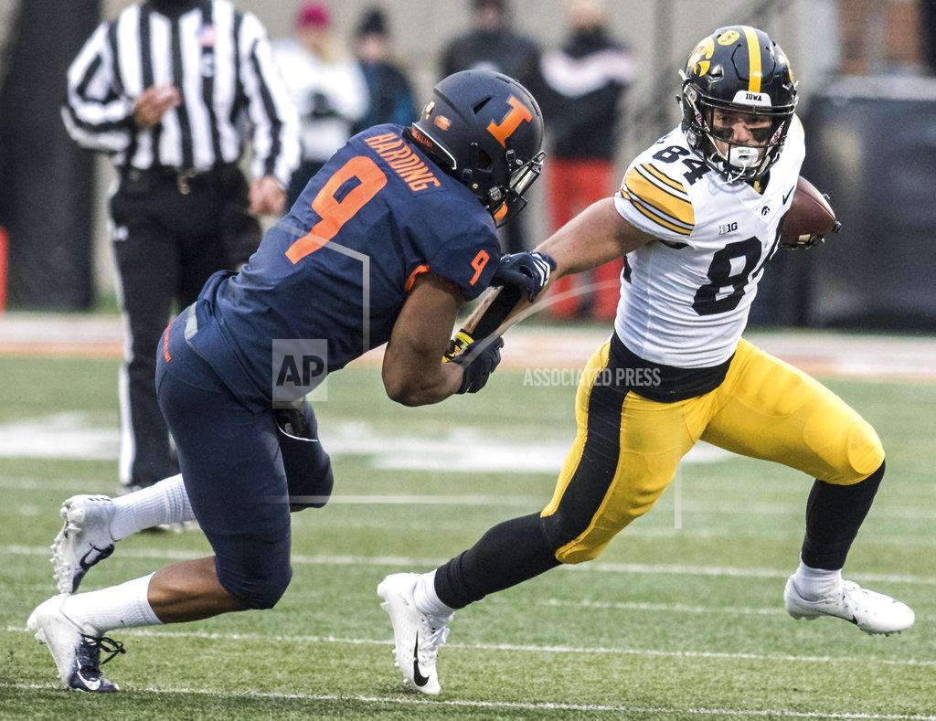 Holly Hart Iowa's Nick Esley (84) runs past Illinois' Dele Harding after making a catch in the first half of a NCAA college football game, Saturday, Nov. 17, 2018, in Champaign, Ill. (AP Photo/Holly Hart)