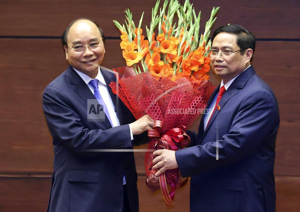 Hoang Thong Nhat Vietnamese newly elected President Nguyen Xuan Phuc, left, and newly elected Prime Minister Pham Minh Chinh pose for a photo in the National Assembly in Hanoi, Vietnam on Monday, April 5, 2021. Vietnam's legislature voted Monday to make Pham Minh Chinh, a member of the Communist party's central committee for personnel and organization, the country's next prime minister. Outgoing Prime Minister Nguyen Xuan Phuc was appointed the new president. (Hoang Thong Nhat/VNA via AP)