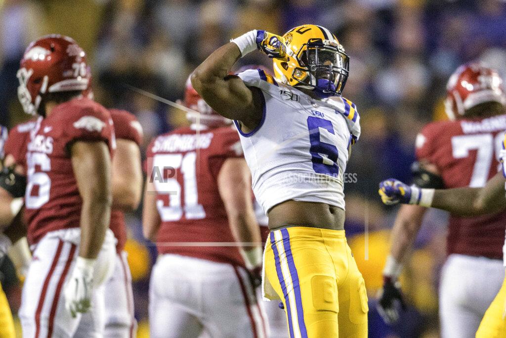 Matthew Hinton LSU linebacker Jacob Phillips (6) celebrates a sack of Arkansas quarterback K.J. Jefferson (1) during the first half of an NCAA college football game in Baton Rouge, La., Saturday, Nov. 23, 2019. (AP Photo/Matthew Hinton)