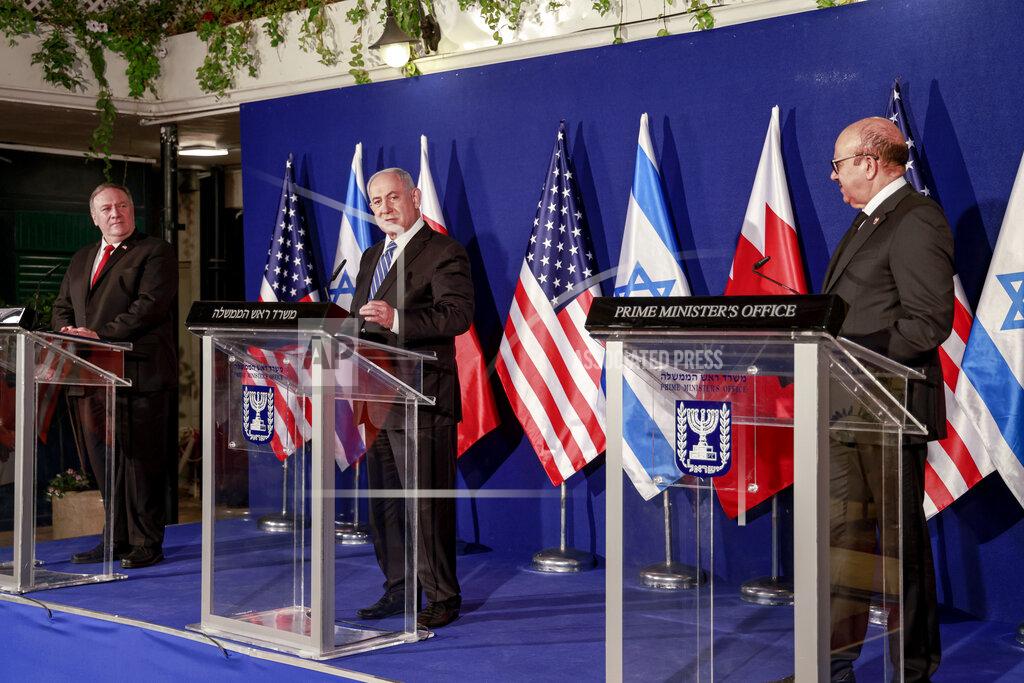 Menahem Kahana U.S. Secretary of State Mike Pompeo, left, and Bahrain's Foreign Minister Abdullatif bin Rashid Alzayani, right, listen as Israeli Prime Minister Benjamin Netanyahu speaks during a joint press conference after their trilateral meeting in Jerusalem on Wednesday, Nov. 18, 2020. (Menahem Kahana/Pool via AP)