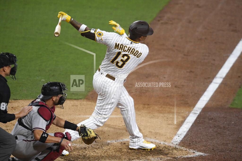 Denis Poroy San Diego Padres' Manny Machado follows through on a single during the sixth inning of the team's baseball game against the Arizona Diamondbacks on Saturday, April 3, 2021, in San Diego. (AP Photo/Denis Poroy)