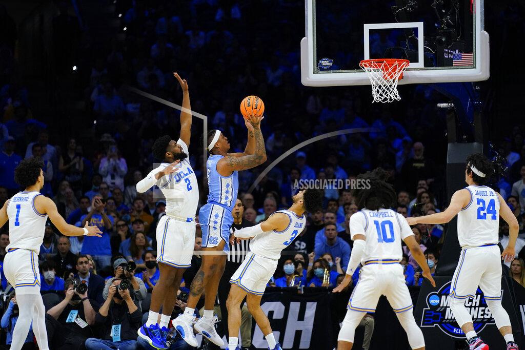 Matt Rourke North Carolina's Armando Bacot, center, goes up for a shot between UCLA's Cody Riley, left, and Johnny Juzang during the first half of a college basketball game in the Sweet 16 round of the NCAA tournament, Friday, March 25, 2022, in Philadelphia. (AP Photo/Matt Rourke)