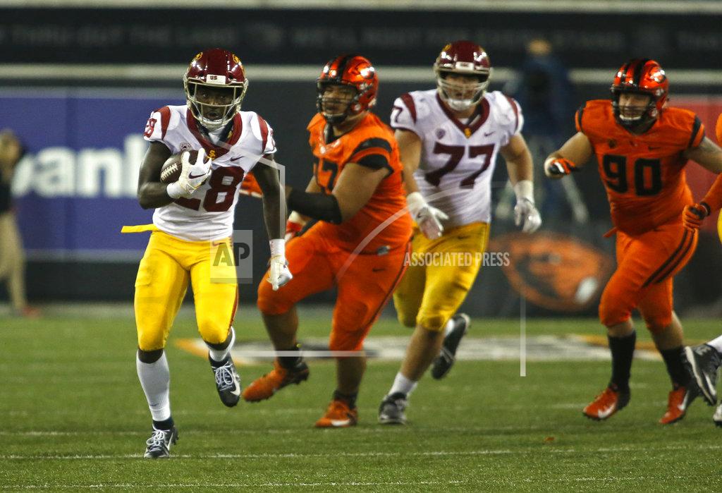 Timothy J. Gonzalez Southern California's Aca'Cedric Ware (28) breaks through the line and heads up field against Oregon State in the second half of an NCAA college football game in Corvallis, Ore., on Saturday, Nov. 3, 2018. Southern California won 38-21. (AP Photo/Timothy J. Gonzalez)