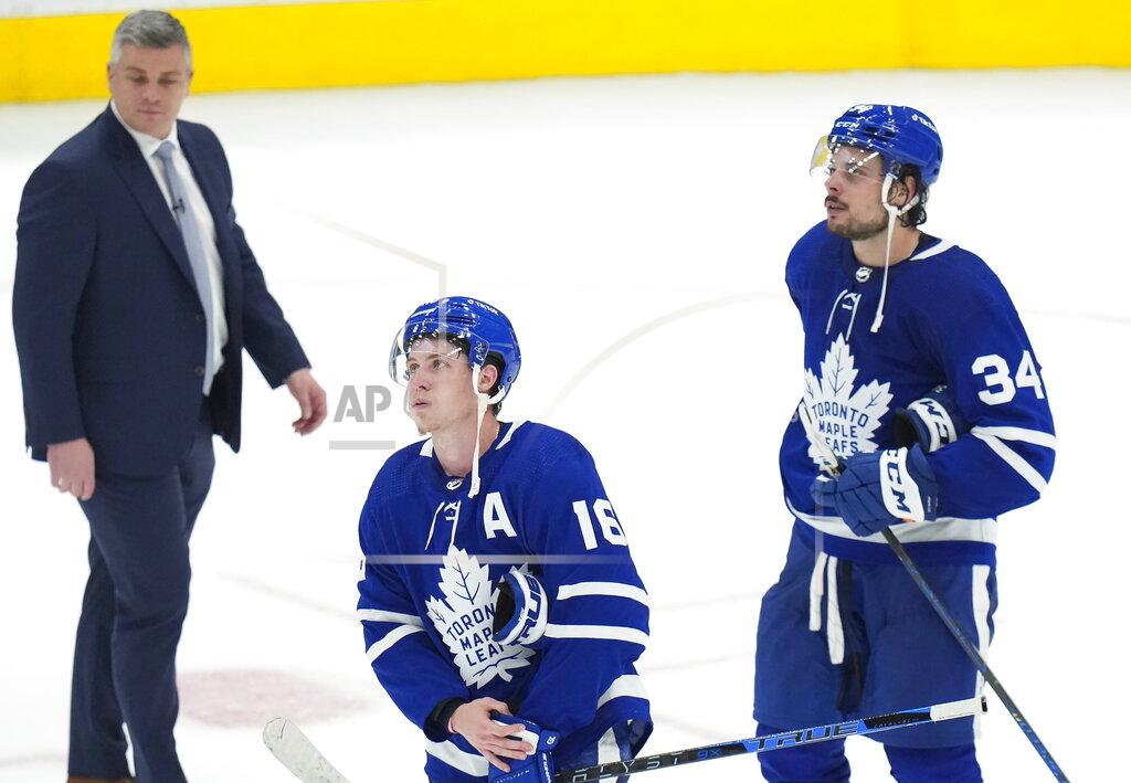 Nathan Denette Toronto Maple Leafs forward Mitchell Marner (16) and teammate Auston Matthews (34) look on next to their head coach Sheldon Keefe after being knocked out of the Stanley Cup playoffs in Game 7 of an NHL hockey first-round playoff series against the Tampa Bay Lightning in Toronto, Saturday, May 14, 2022. (Nathan Denette/The Canadian Press via AP)