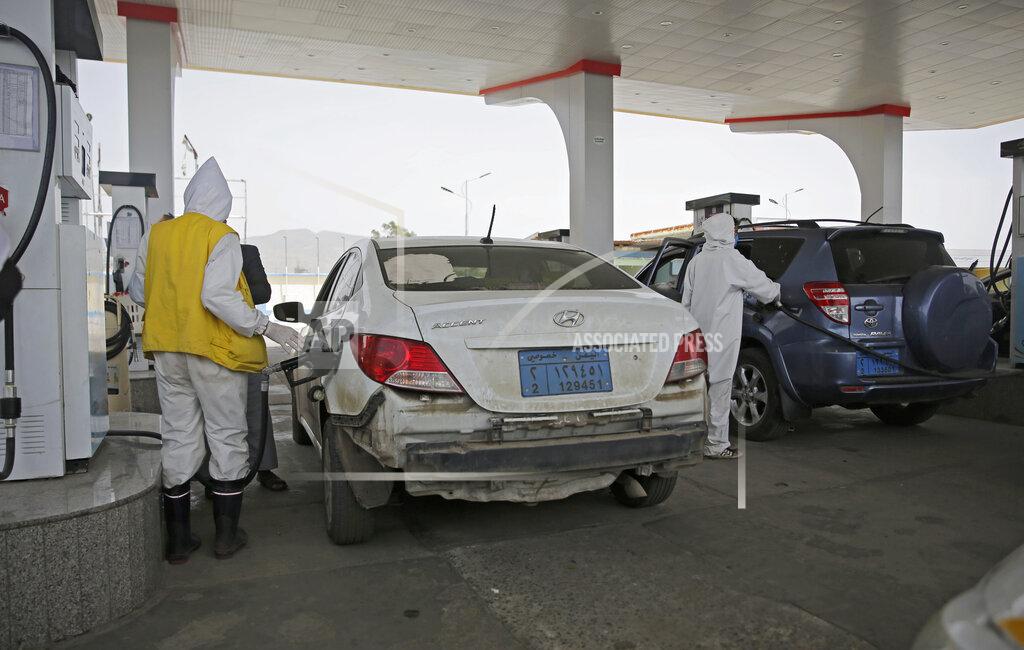 Hani Mohammed Yemeni attendants wearing personal protective equipment pump fuel at a petrol station amid fuel shortages in Sanaa, Yemen, Monday, June 15, 2020. (AP Photo/Hani Mohammed)