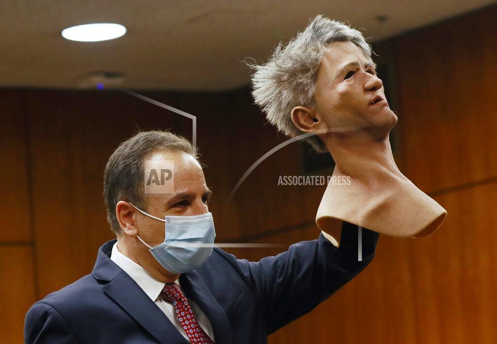 Al Seib Deputy District Attorney Habib A. Balian holds a rubber latex mask, worn by Robert Durst when police arrested him, Wednesday, Sept. 8, 2021 in Inglewood, Calif. Robert Durst is a champion at running from responsibility, covering his tracks with lies so numerous he couldn't keep them all straight, a prosecutor said Wednesday during closing arguments in the New York real estate heir's murder trial. (Al Seib/Los Angeles Times via AP, Pool)