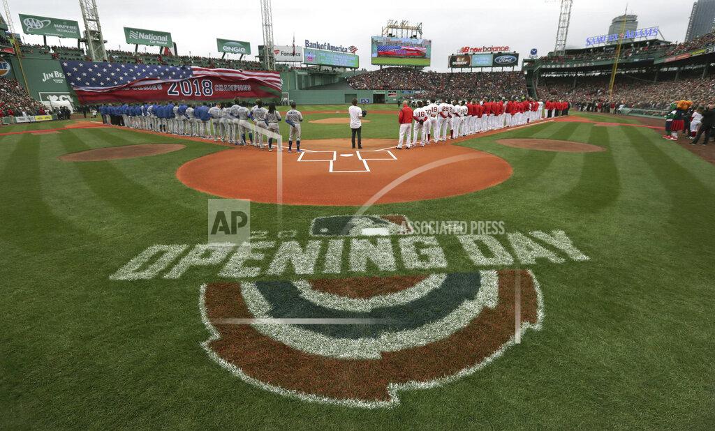 Charles Krupa The Toronto Blue Jays, left, and Boston Red Sox stand along the base lines during the national anthem before the home opener baseball game, Tuesday, April 9, 2019, in Boston. (AP Photo/Charles Krupa)