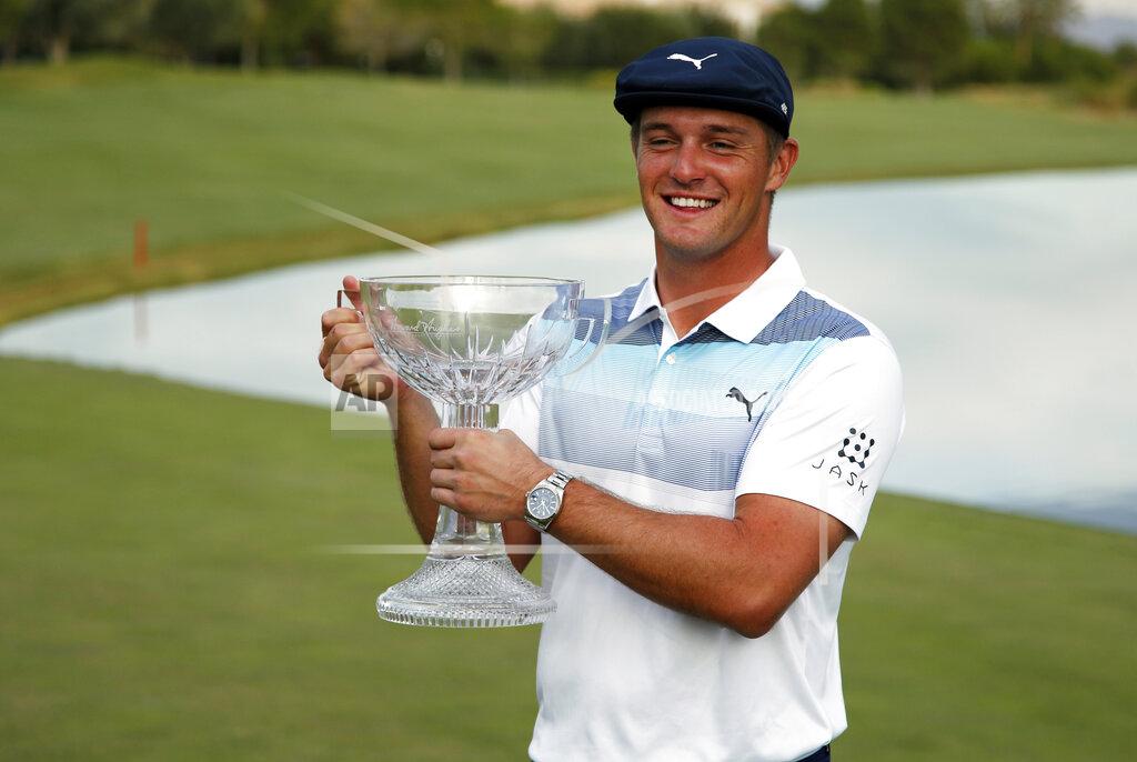 John Locher FILE - In this Nov. 4, 2018, file photo, Bryson DeChambeau holds the trophy after winning the Shriners Hospitals for Children Open golf tournament at the TPC Summerlin in Las Vegas. DeChambeau has added more than 40 pounds of mass in an effort to hit the ball extraordinary distances. He now is the betting favorite at the Masters next week. (AP Photo/John Locher, File)