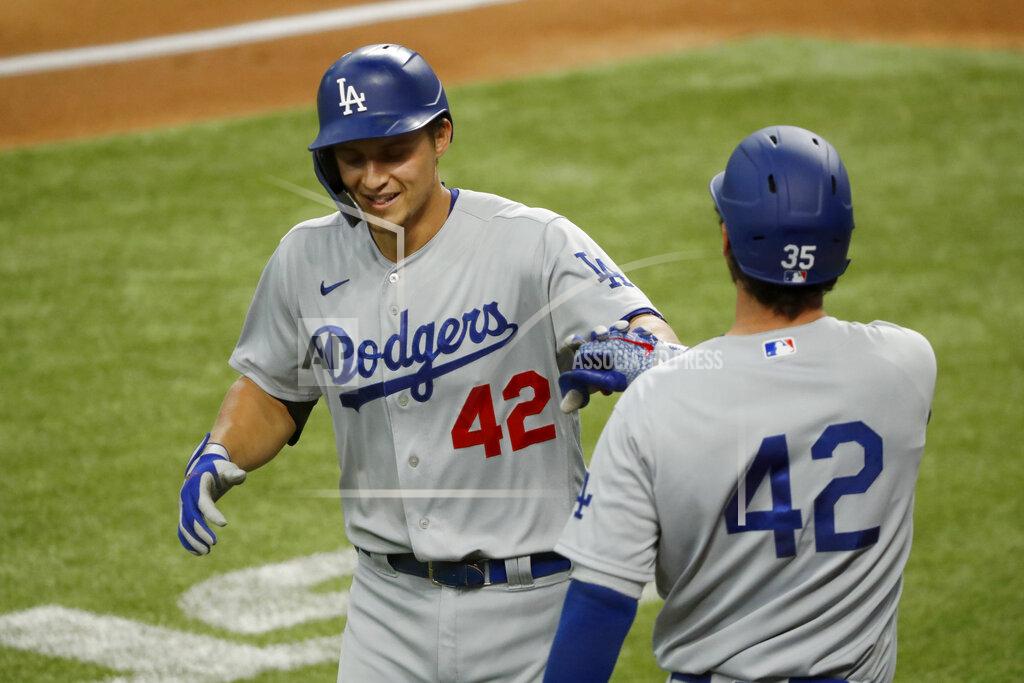 Roger Steinman Los Angeles Dodgers' Corey Seager, left, is congratulated by Cody Bellinger, right, after a solo home run during the first inning of a baseball game against the Texas Rangers in Arlington, Texas, Sunday, Aug. 30, 2020. (AP Photo/Roger Steinman)