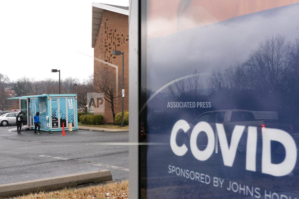 Jacquelyn Martin In this Thursday, Feb. 11, 2021, photo people arrive for COVID-19 vaccinations at a clinic outside the Pennsylvania Avenue Baptist Church, Thursday, Feb. 11, 2021, in southeast Washington. (AP Photo/Jacquelyn Martin)