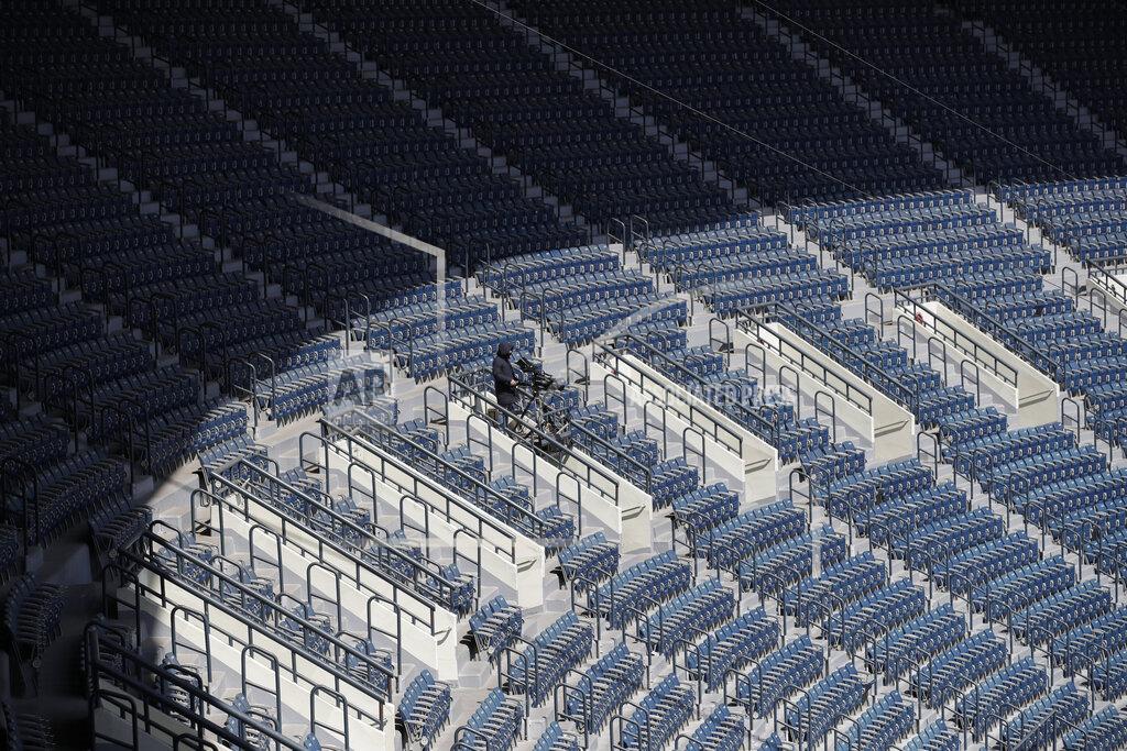 Lee Jin-Man FILE - In this April 21, 2020, file photo, a TV cameraman works in rows of empty seats during a preseason baseball game between Doosan Bears and LG Twins in Seoul, South Korea. (AP Photo/Lee Jin-man, File)